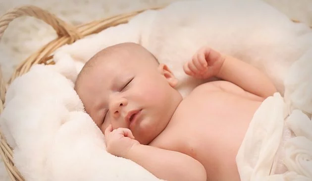 baby lying in basket