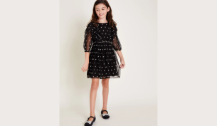 Young girl models the Star print tulle black dress by Monsoon