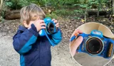 A young boy in the woods using the VTECH KidiZoom Duo FX camera. Inset is a close-up image of the camera