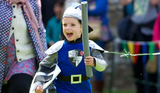 A little boy dressed as a knight at an English Heritage destination