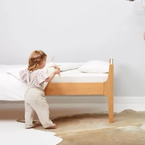 The Little Green Sheep Organic Wool Pillow for Toddlers in use in a bedroom