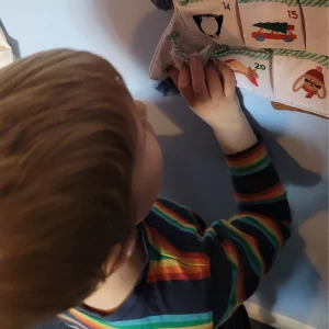JoJo Maman Bebe hanging advent calendar in testing close up showing child