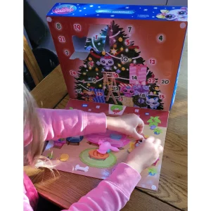 Littlest Pet Shop Holiday Advent Calendar in testing showing child placing a sticker
