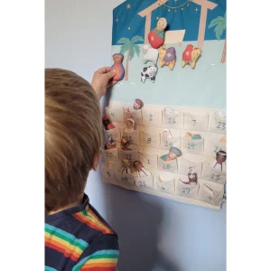 JoJo Maman Bebe Hanging Advent Calendar in testing showing child placing the figures