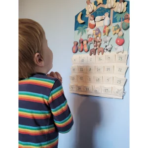 JoJo Maman Bebe Hanging Advent Calendar in testing showing child reacting to the finished nativity scene