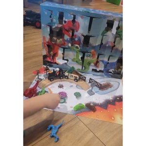 BRIO advent calendar in testing showing child's arm placing the dinosaurs