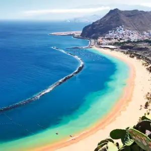 Aerial shot showing a stretch of long, sandy beach in Tenerife