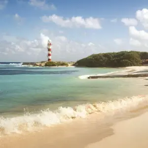Shoreline and lighthouse of a tropical beach in Mexico