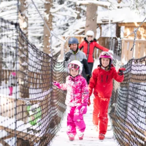 Avoriaz, France wide shot showing family walking across a bridge in ski gear
