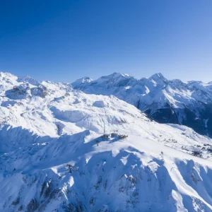 La Plagne, France wide aerial shot of mountains and ski lift, piste