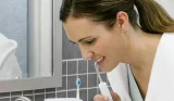 Woman using water flosser