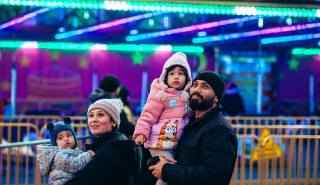 A family enjoy Winter Wonderland in London