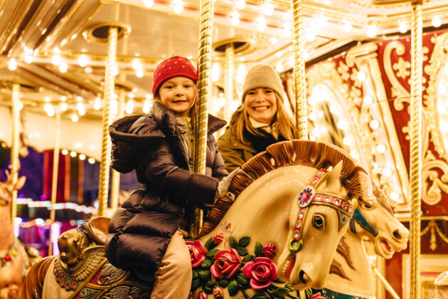 A mother and daughter on the carousel at Winter Wonderland