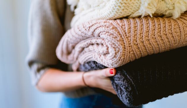 Woman carrying pile of washing