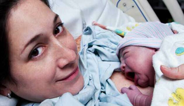 Woman and newborn baby in hospital