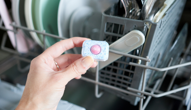 Woman holding a dishwasher tablet