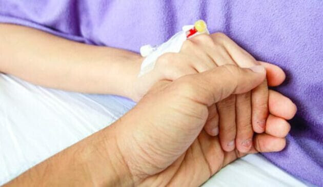 Pregnant woman holding hand