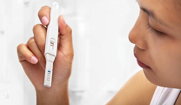 Woman looking at pregnancy test