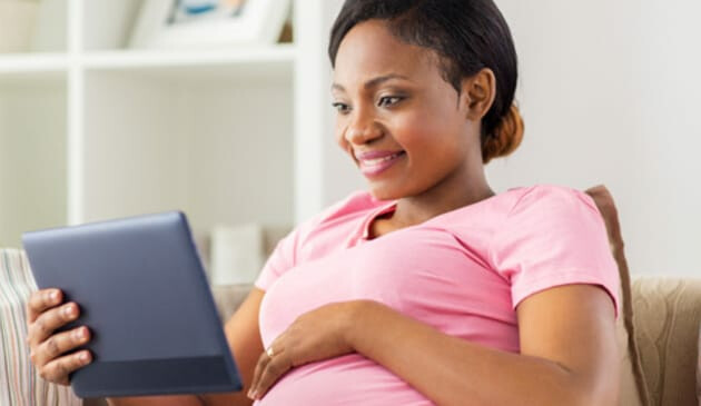 Pregnant woman using a tablet