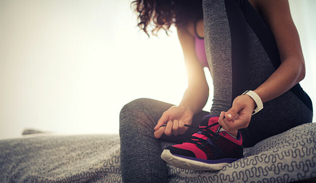 Woman tying laces up