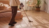 Woman vacuuming with a cordless vacuum