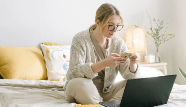 Woman on phone and laptop