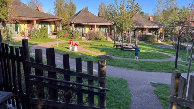 Two children play on playground equipment at Woodland Lodges in Alton Towers