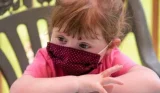 Small child in face mask