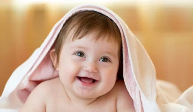 Baby smiling in towel