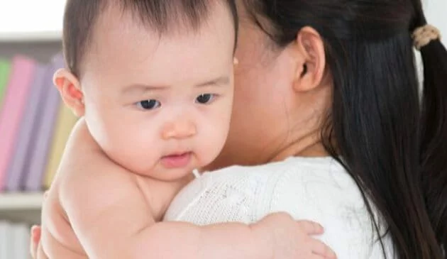Baby being held by mother