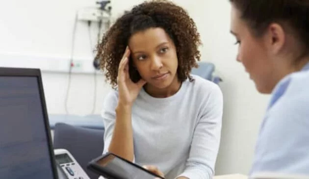 Woman at a doctors consulation