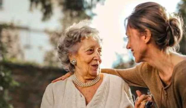 Younger woman with arm around older woman