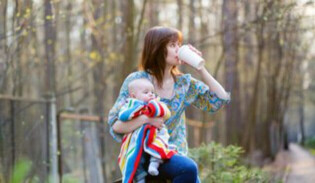 Mum drinking coffee with baby