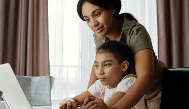 mother and child using laptop together