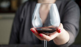 Woman holding glass of wine