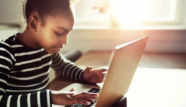 young girl working on laptop