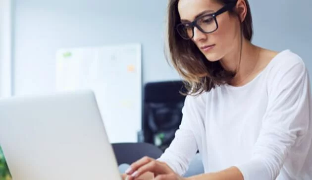 Woman reading on laptop