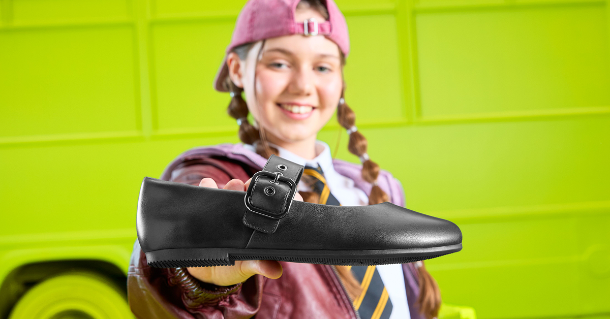 Girl holding Clarks school shoe