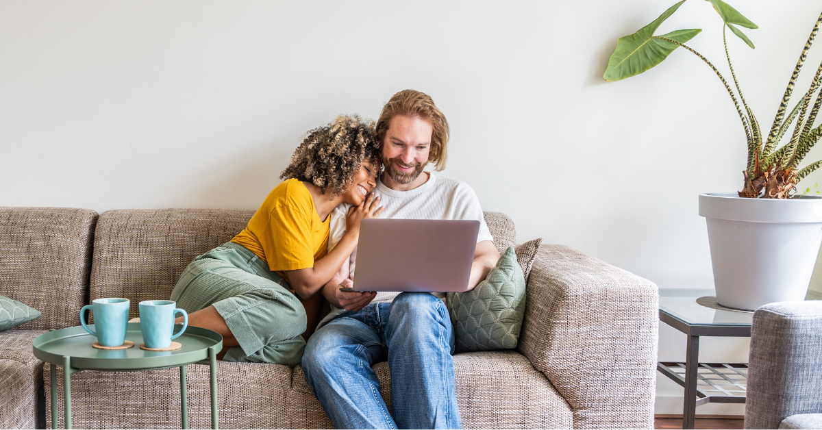 Couple on laptop smiling
