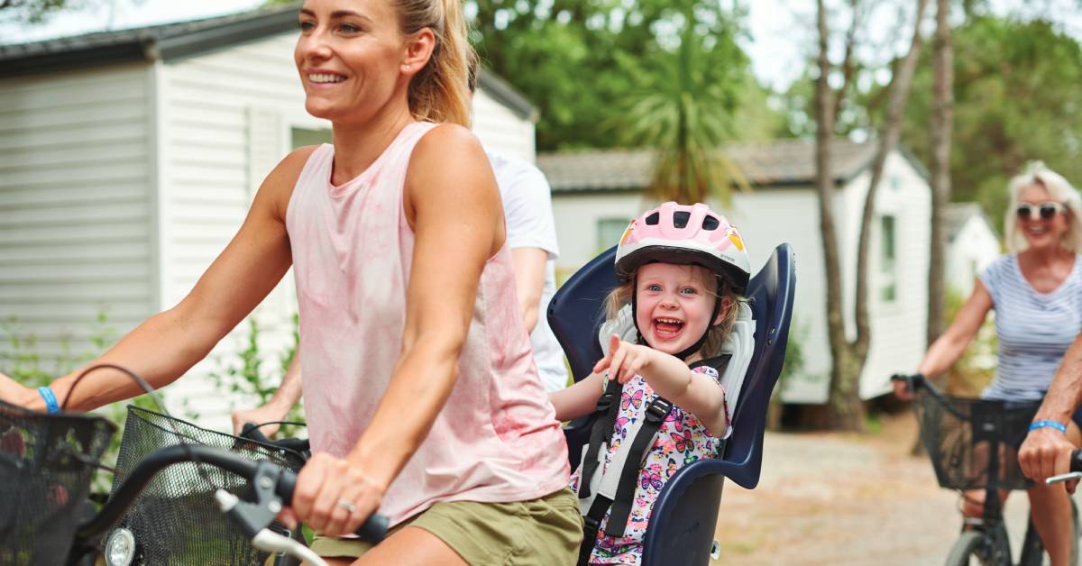 A woman and child on a bike at a Eurocamp site