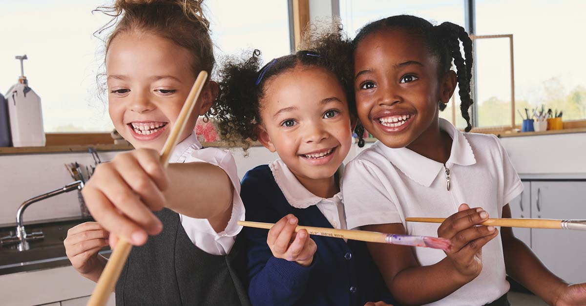Three children wearing NEXT back to school clothing